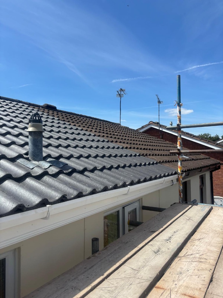 Scaffolding staging view of bungalow extension retiling and flue pipe fitting